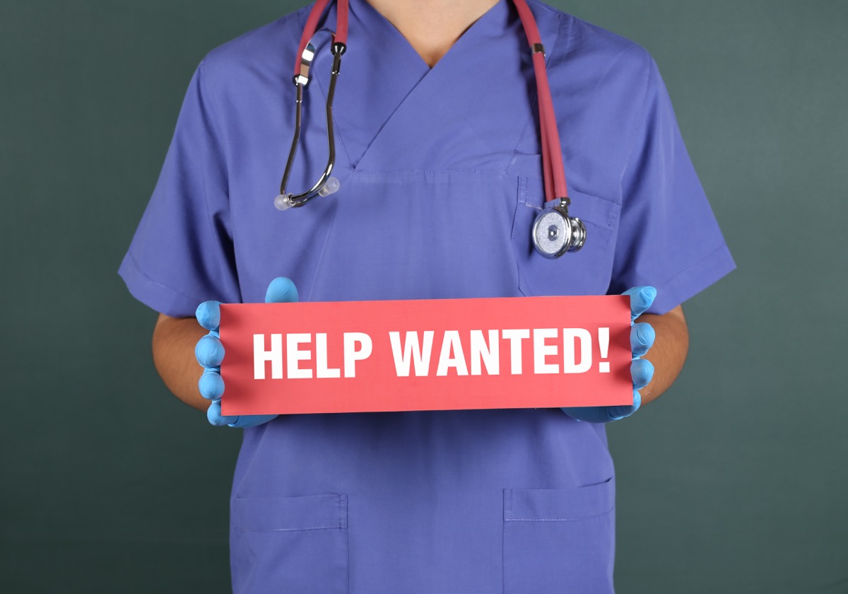 Doctor Holding a Sign "Help Wanted
