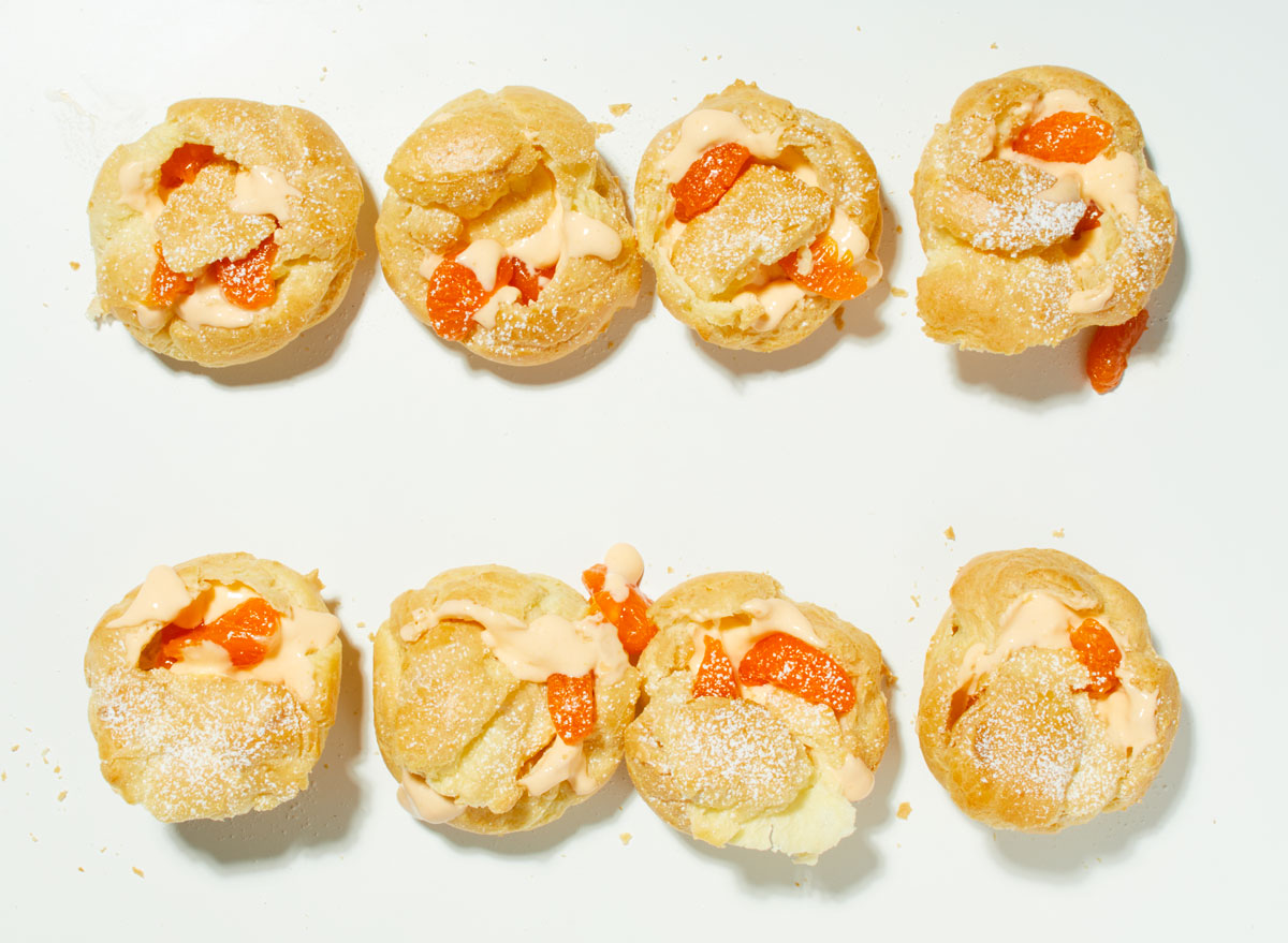 orange cream puffs on a white table