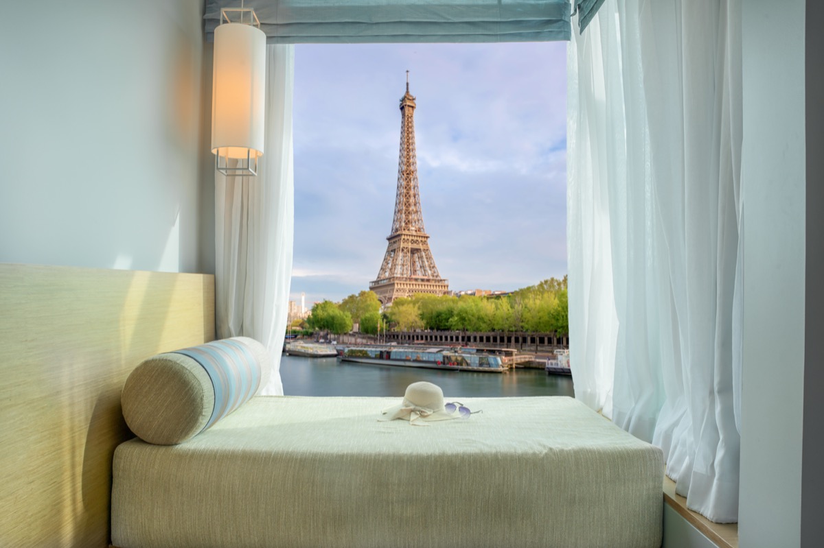 Holiday in Paris ,France. Beautiful Eiffel tower view at window in resort near Seine river, Paris ,France
