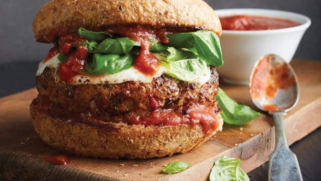 pizza burger on wooden tray with marinara sauce