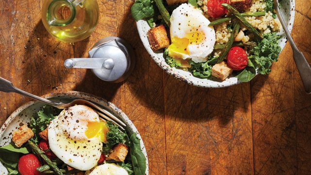 red and green breakfast salad in bowls with eggs and oil