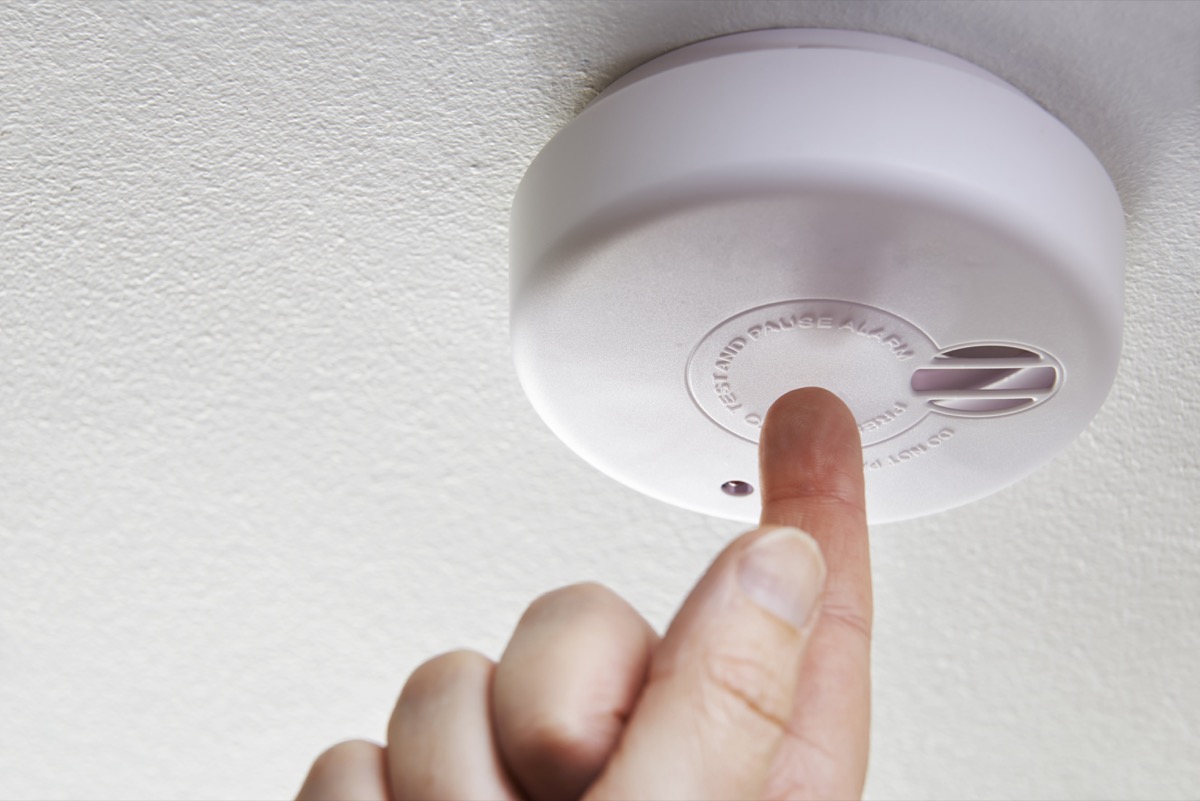 Hand Testing Domestic Smoke Alarm