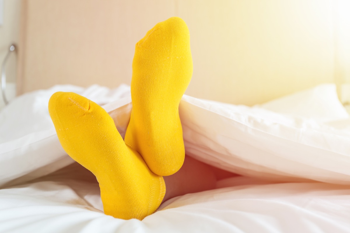 foots of family with color sock on the bed