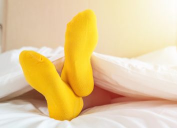 foots of family with color sock on the bed