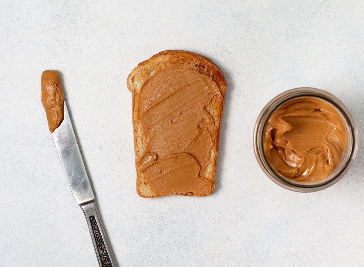 homemade nut butter in a jar spread on toast