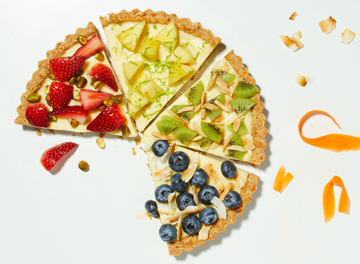 spring fruit and cream tart slices with strawberries, pineapple, kiwi, and blueberries