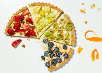 spring fruit and cream tart slices with strawberries, pineapple, kiwi, and blueberries