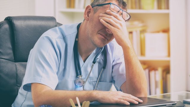 Overworked doctor sitting in his office