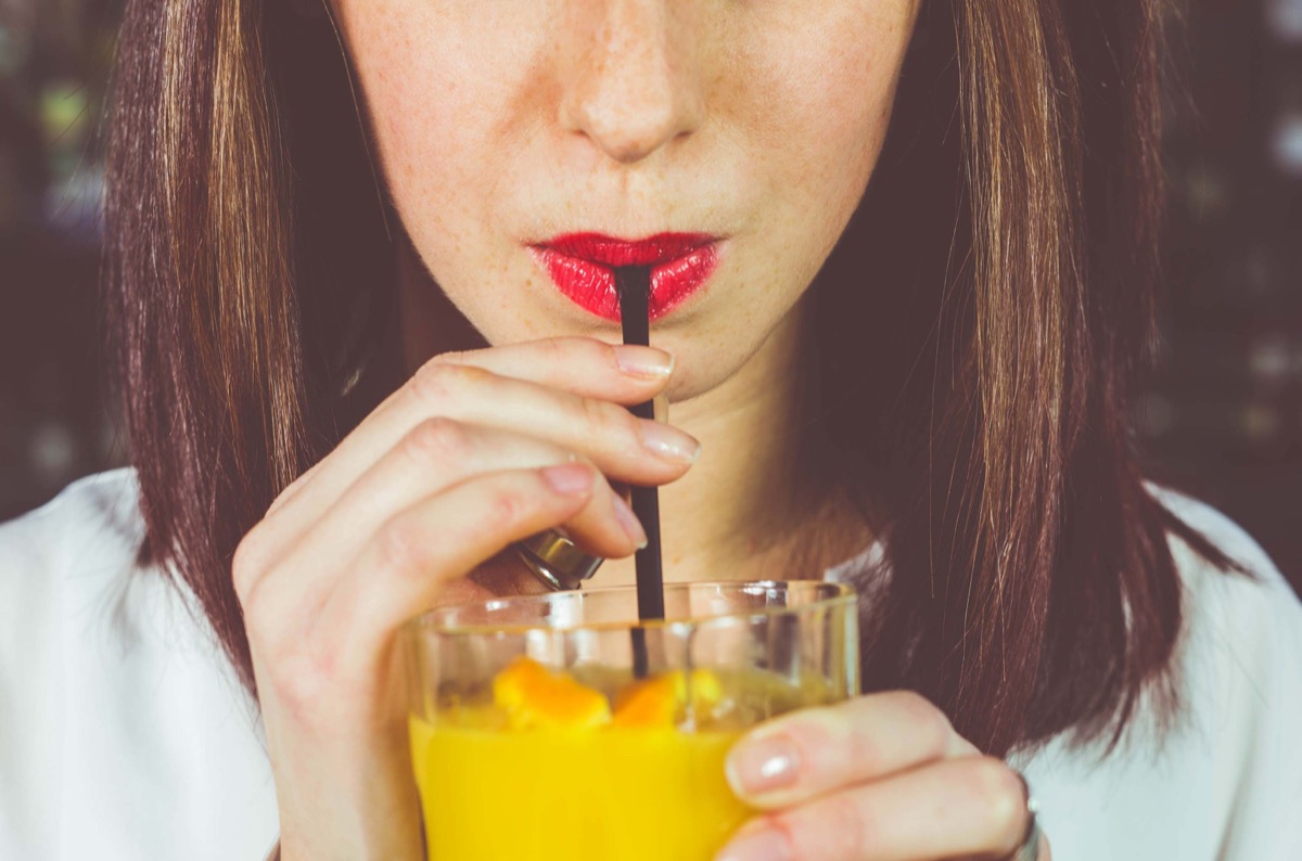 girl drinking a cocktail from straw