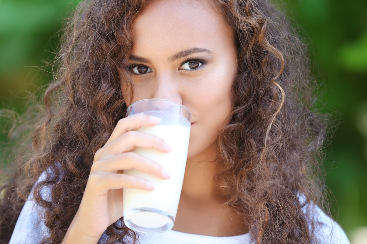woman drinking milk in garden