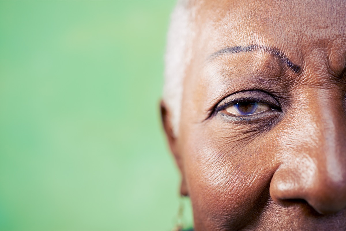 woman portrait, close-up of eye and face on green background