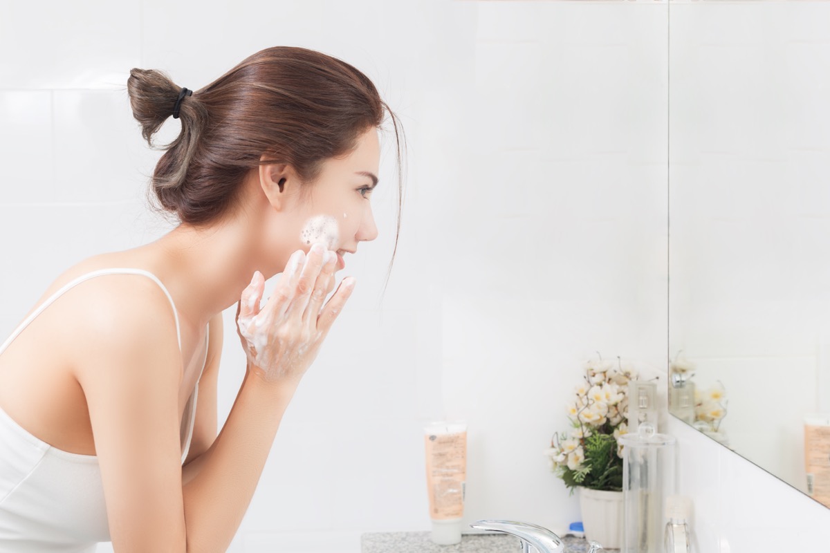woman cleaning face skin enjoy herself with bubble cleansing foam