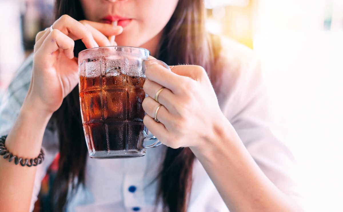 woman drinking ice cola in the glass