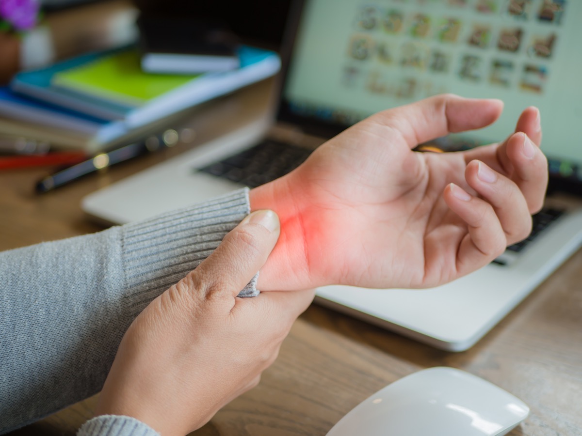 woman holding her wrist pain