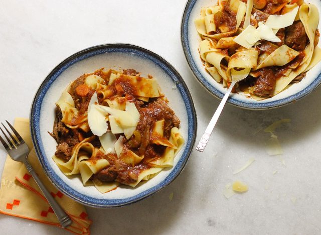 Crock pot beef ragu recipe with pappardelle pasta and shaved parmesan