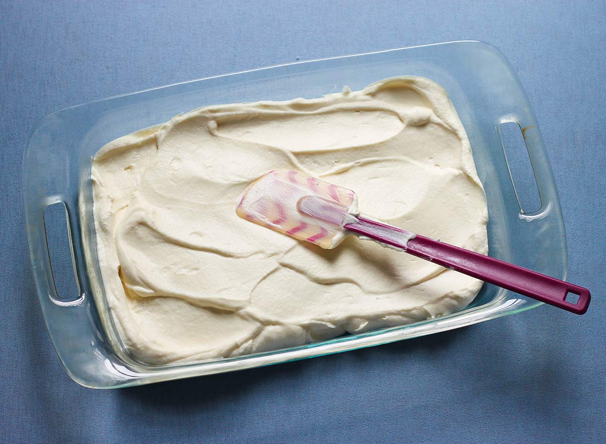 Spreading ice cream mixture into a glass dish