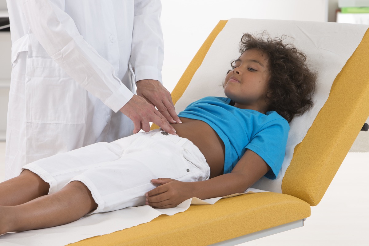 pediatrician doing abdominal examination