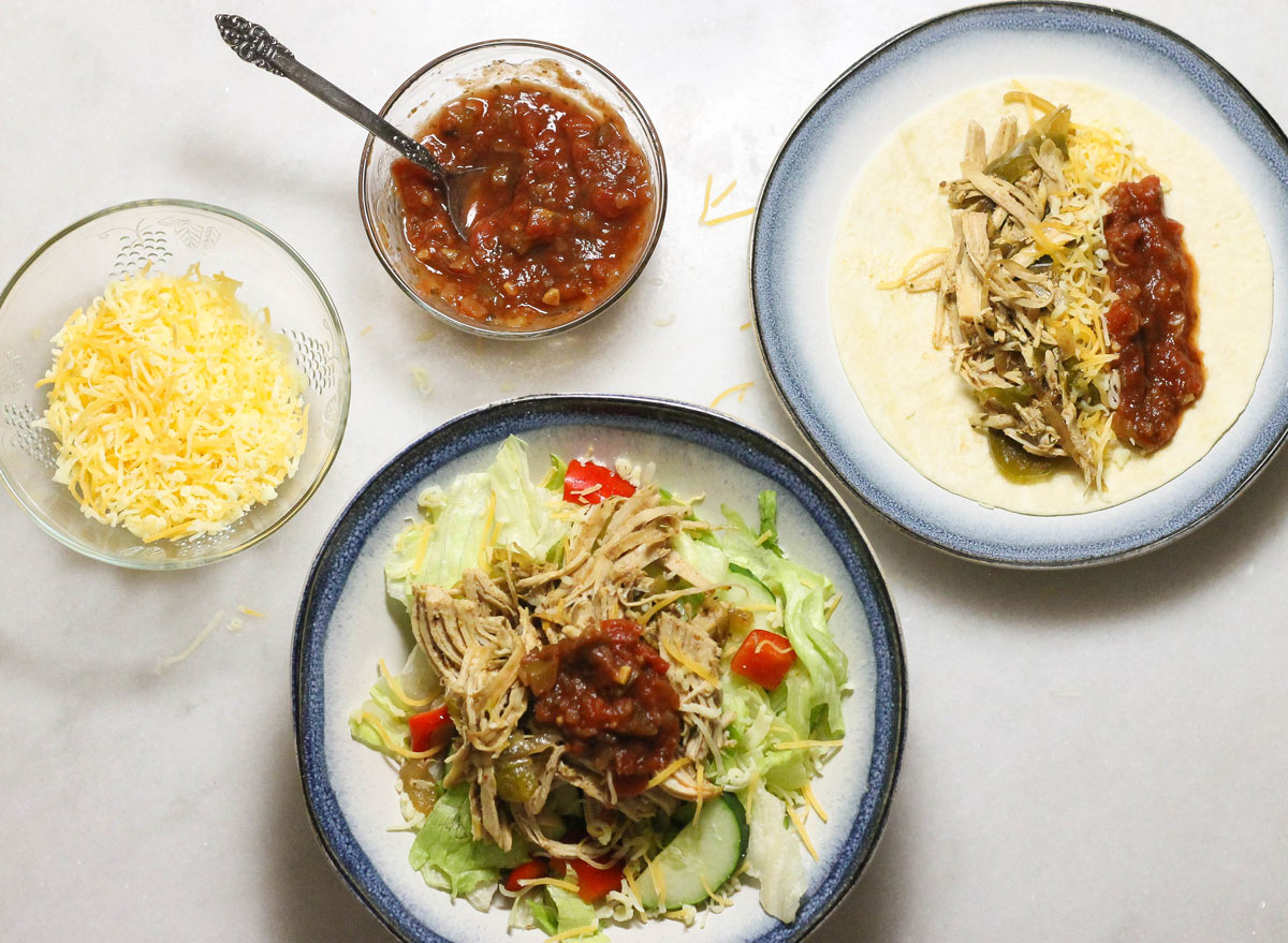 Crock pot chicken tacos in a salad and tortilla