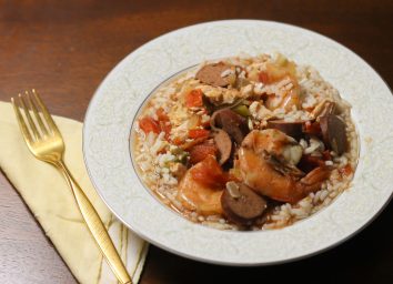 Crock pot jambalaya in a bowl on a bed of rice ready to eat.