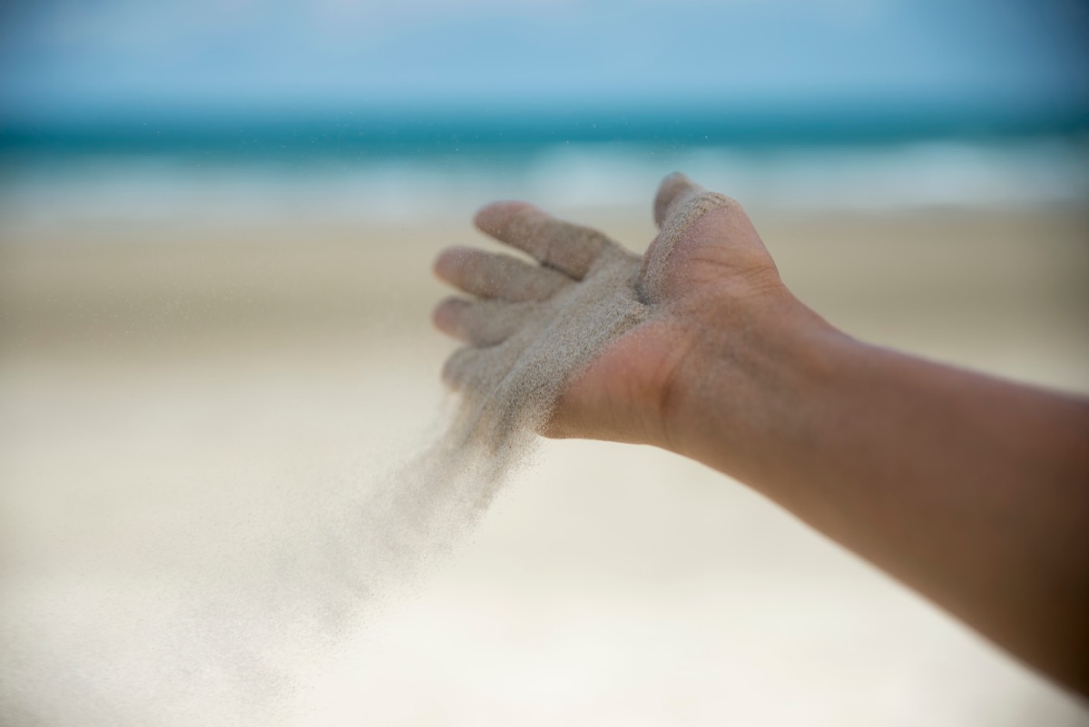 hand release sand on beach