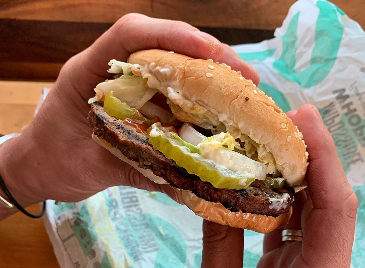 burger king impossible whopper in two hands with wrapper