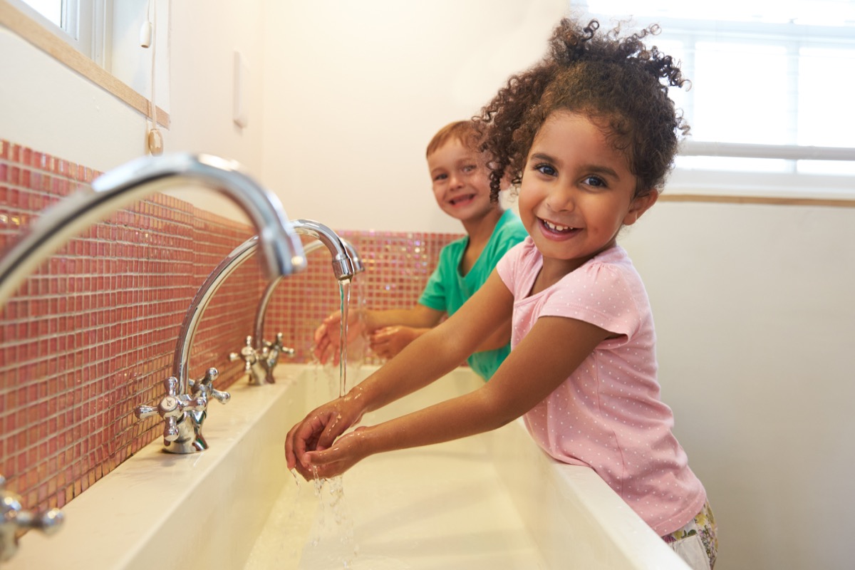 Kids at School Washing Hands In Washroom