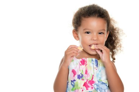 little girl eating cracker, gluten-free snacks
