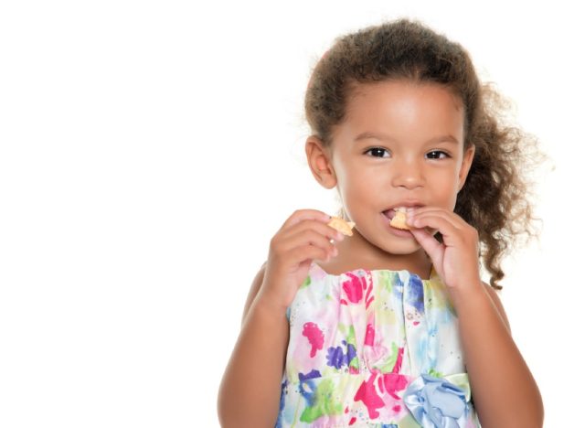 little girl eating cracker, gluten-free snacks