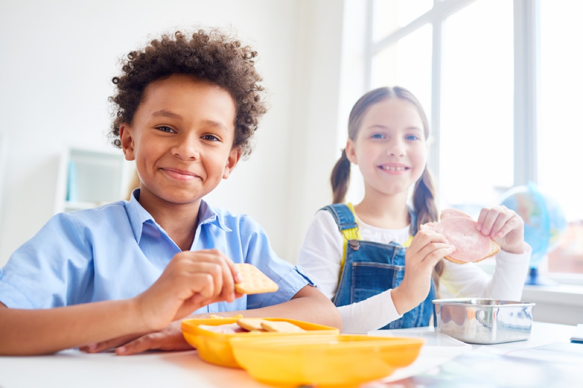 little boy and girl eating snack at school, peanut free preschool snacks