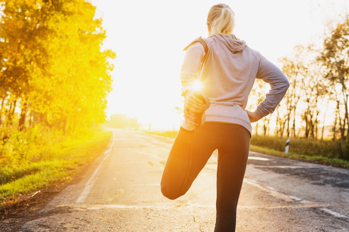 Fitness woman runner stretching legs