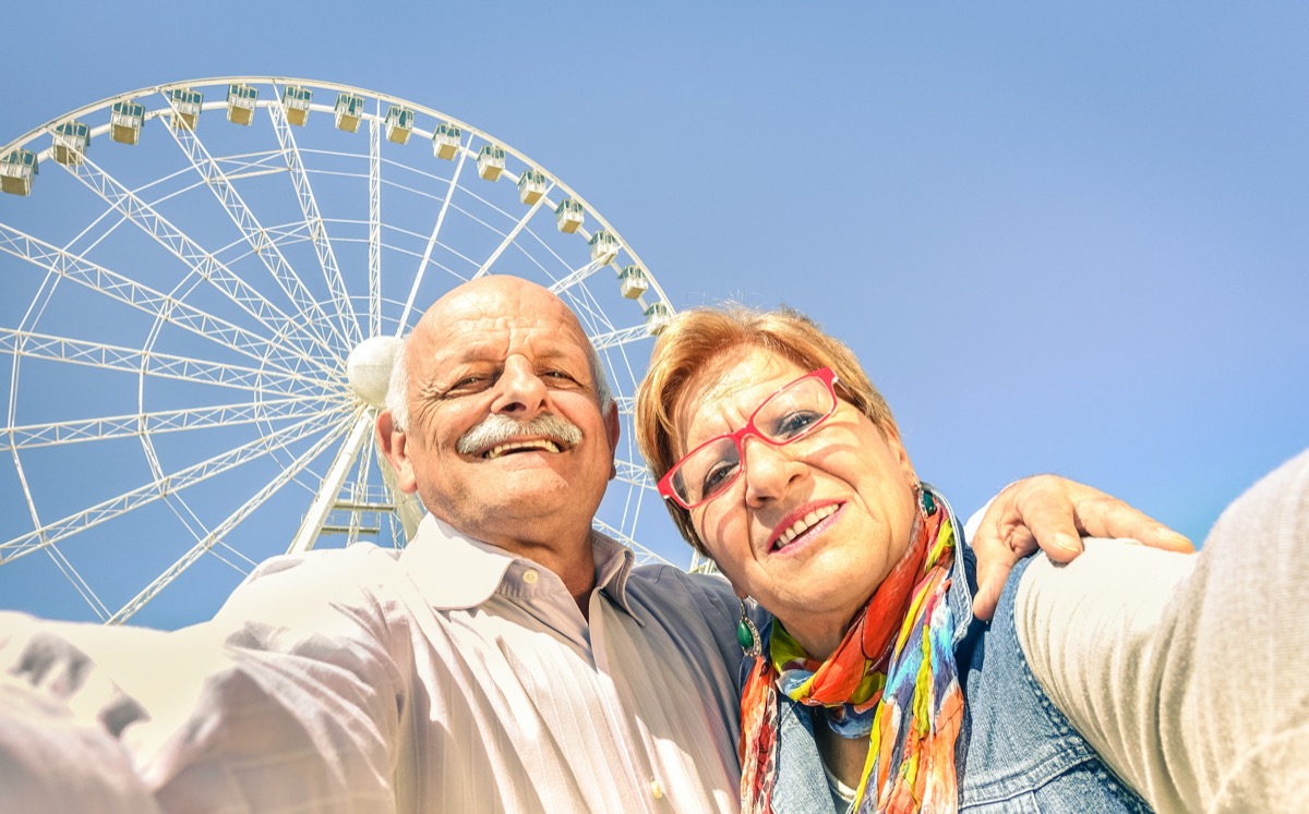 Happy retired senior couple taking selfie at travel around the world