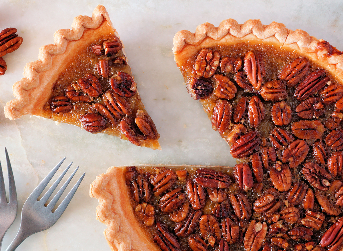 whole pecan pie with slice