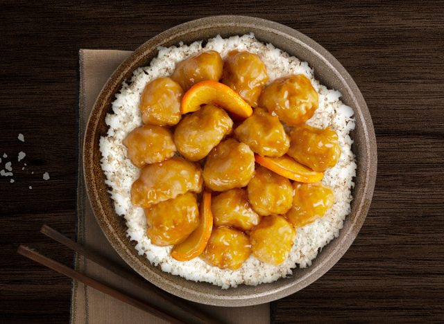 pei wei orange chicken over rice on a plate.