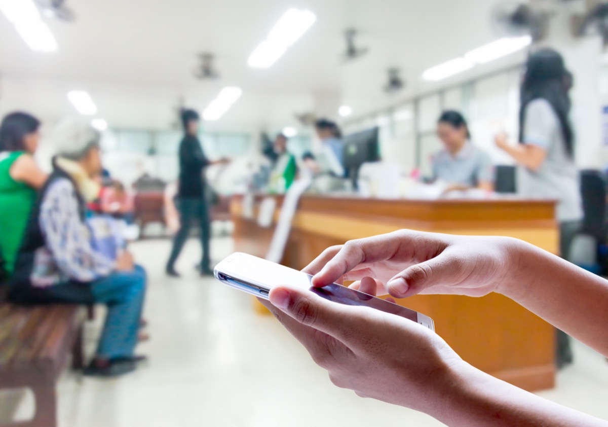 Man use mobile phone, blur image inside hospital