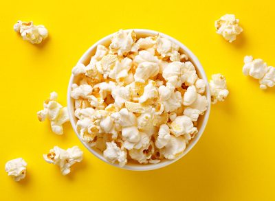 cup of popcorn against yellow backdrop
