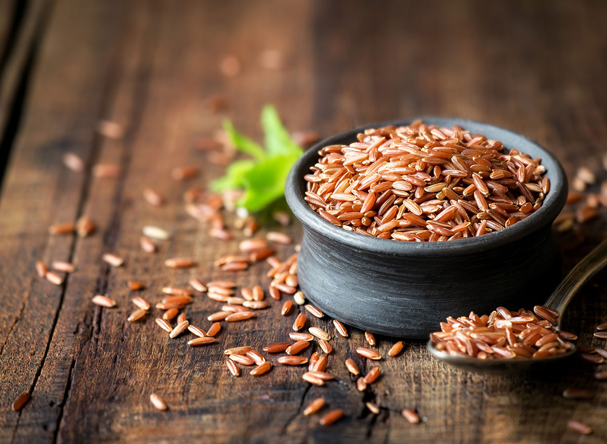 uncooked red rice bowl spoon