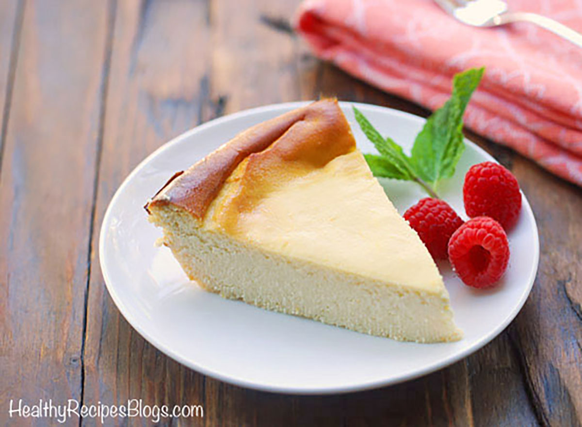 ricotta cheesecake with raspberries on white plate