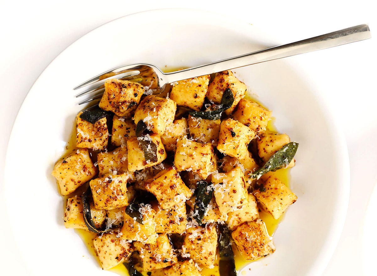 ricotta gnocchi with fork on white plate