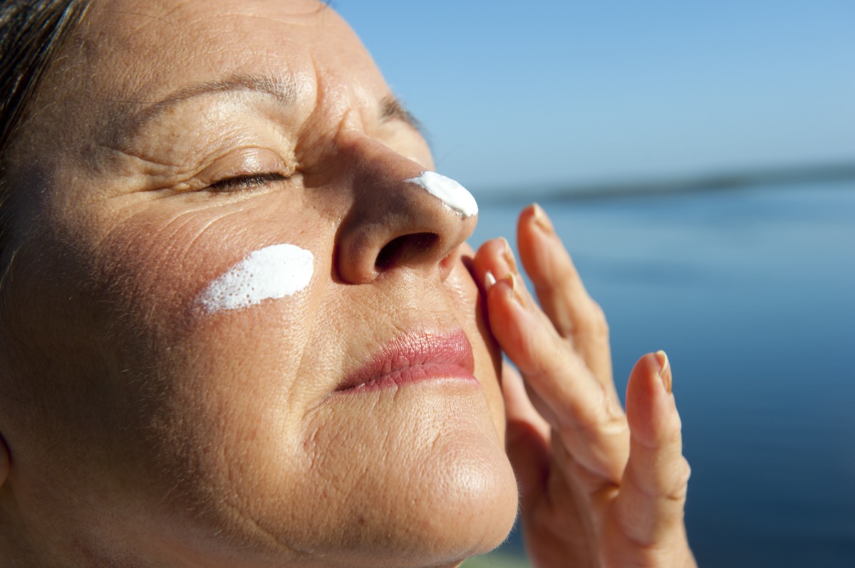 mature woman with suncream on her face