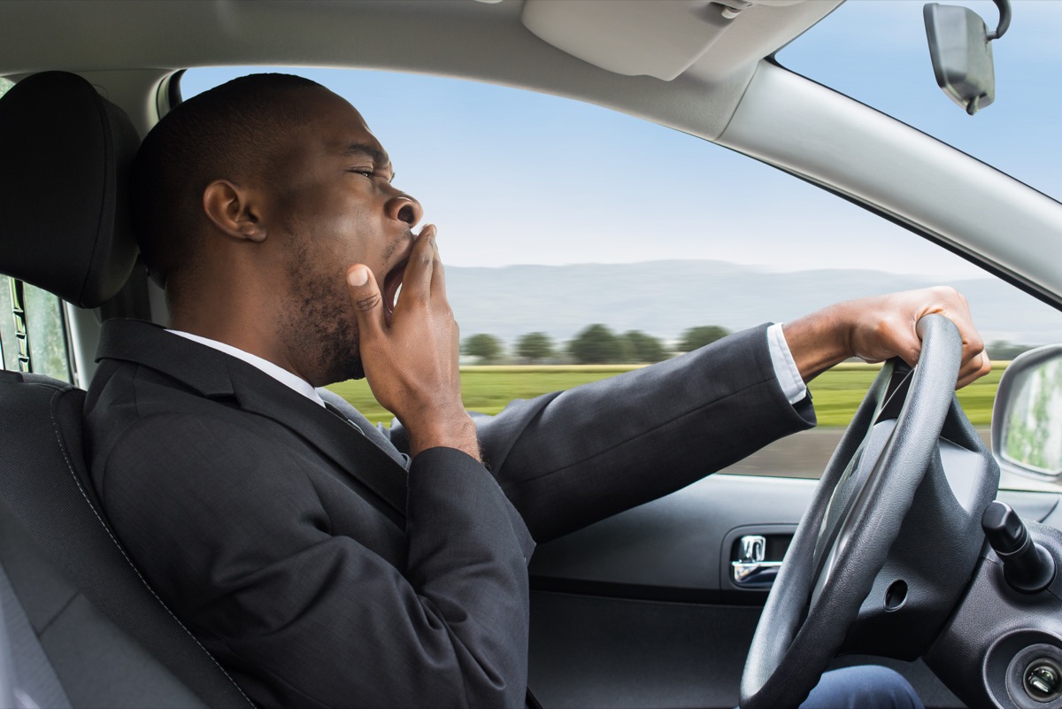 tired businessman driving car - Medplus