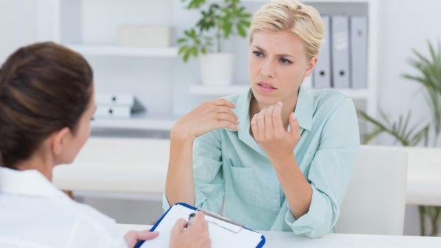 Unhappy patient speaking with doctor in medical office