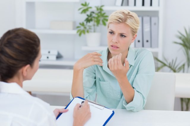 Unhappy patient speaking with doctor in medical office
