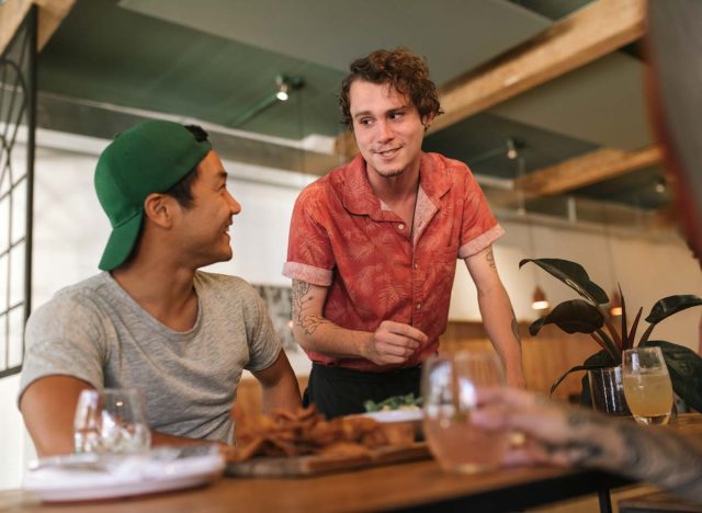 Waiter talking to customer at a restaurant