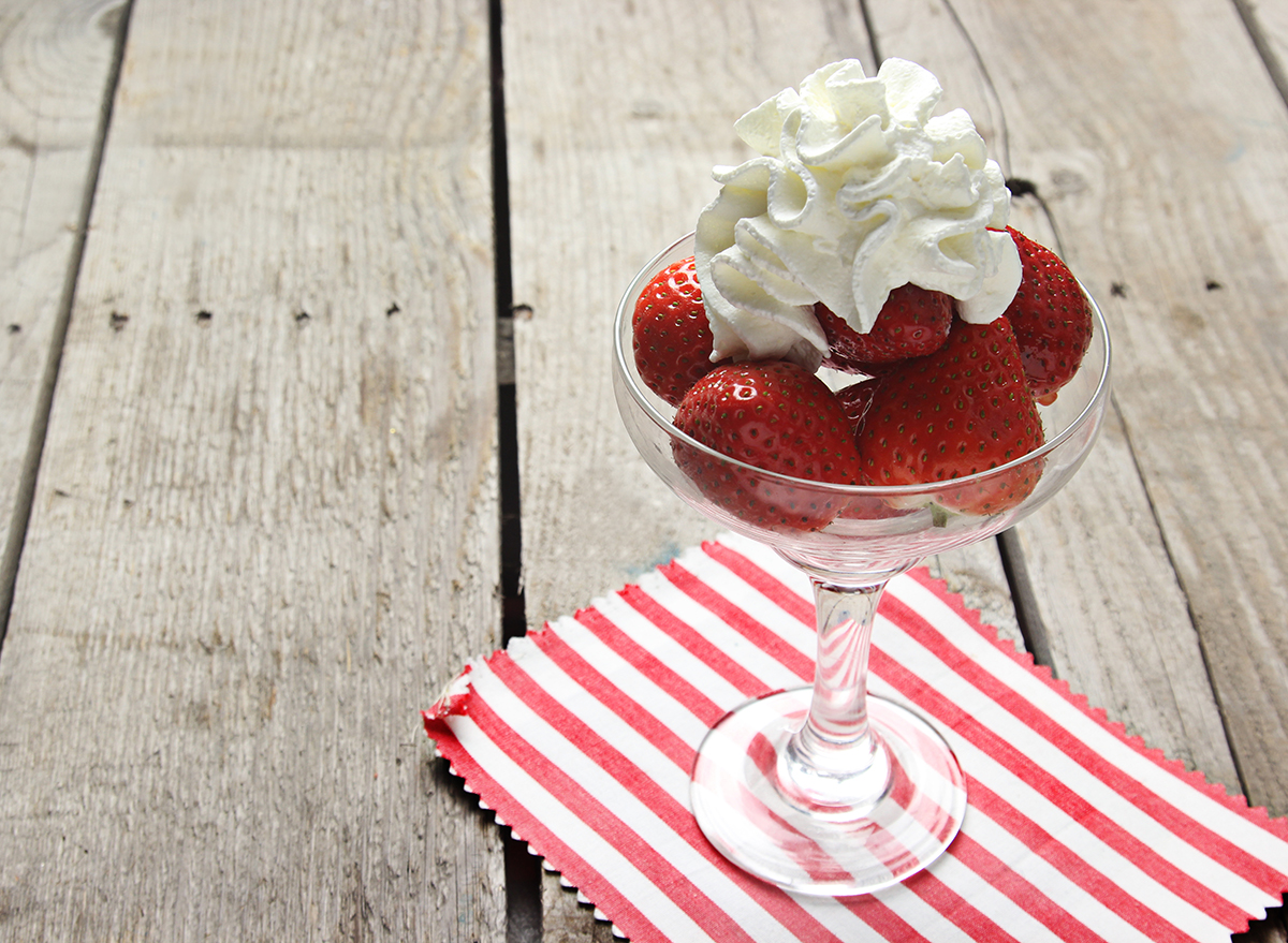 whipped cream on top of strawberries