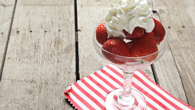 whipped cream on top of strawberries
