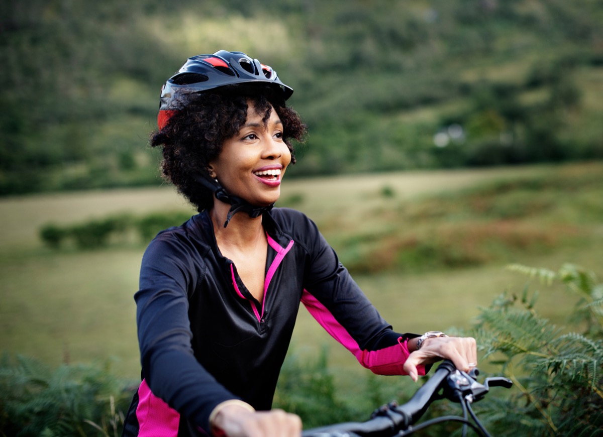 Cheerful female cyclist enjoying a bike ride
