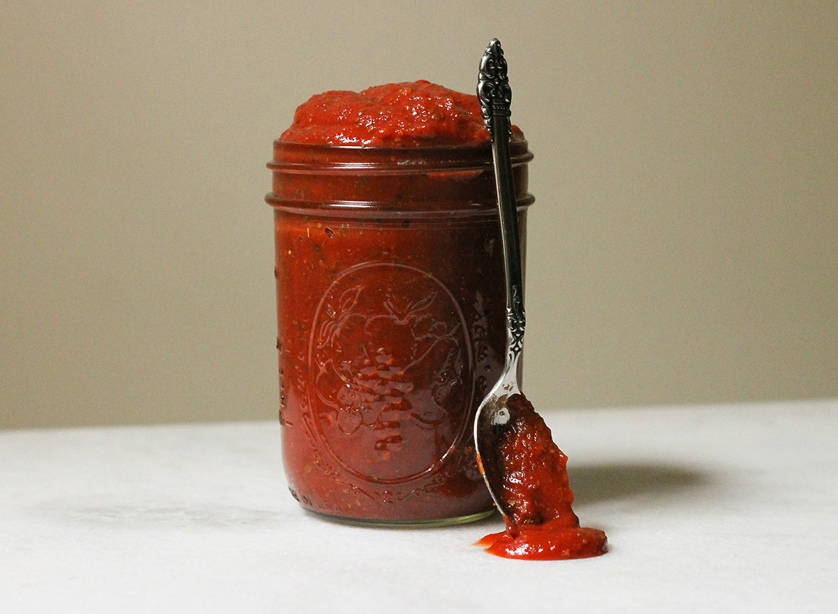 Italian pizza sauce with a spoon in a jar