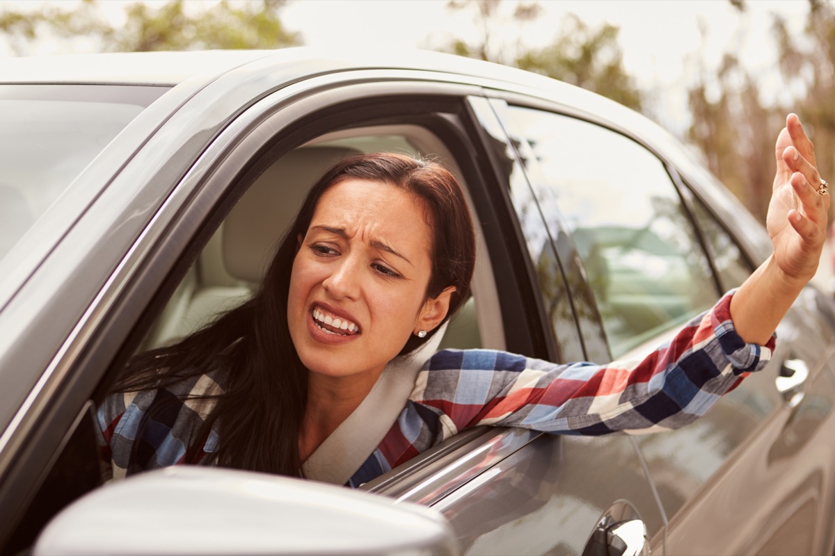 Frustrated Hispanic female driver in a car