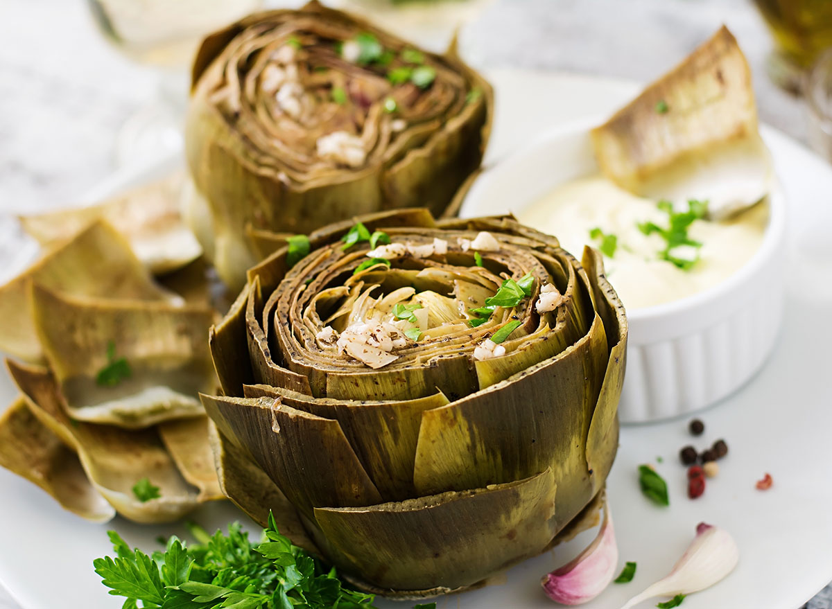 baked artichoke on plate with garnish