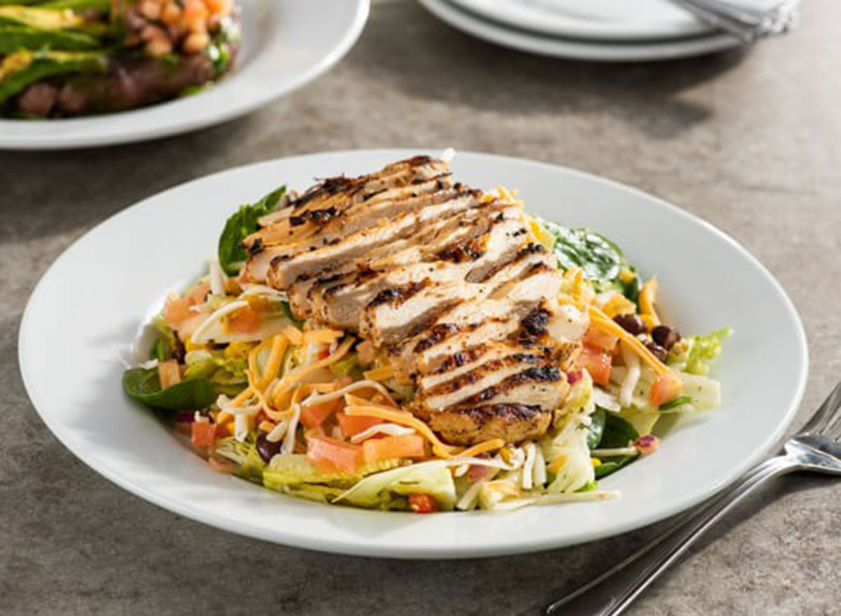 chilis grilled chicken salad in a white bowl